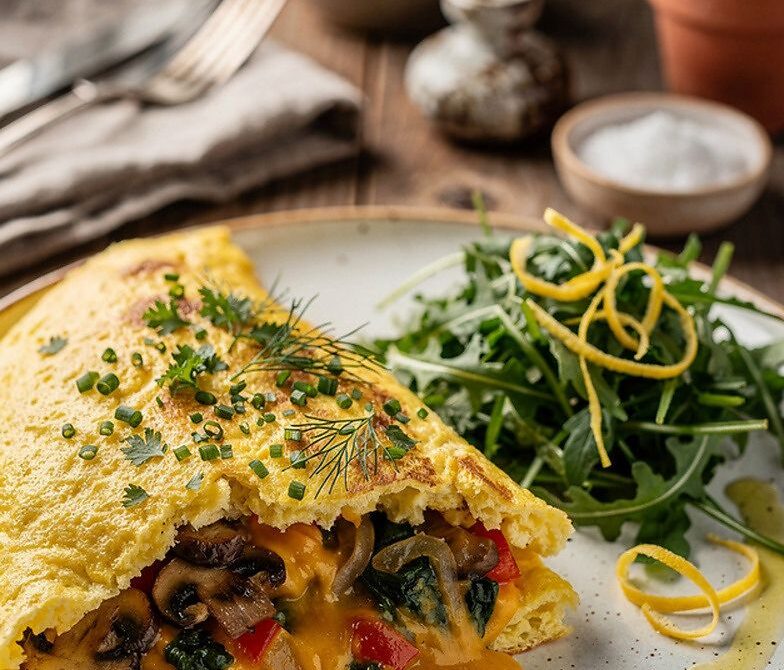 Loaded Veggie Cheddar Omelet With Lemon Herb Arugula Salad