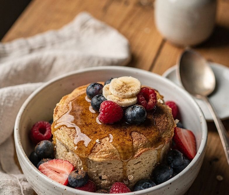 Microwave Banana Oatmeal Pancake Bowl with Maple and Berries
