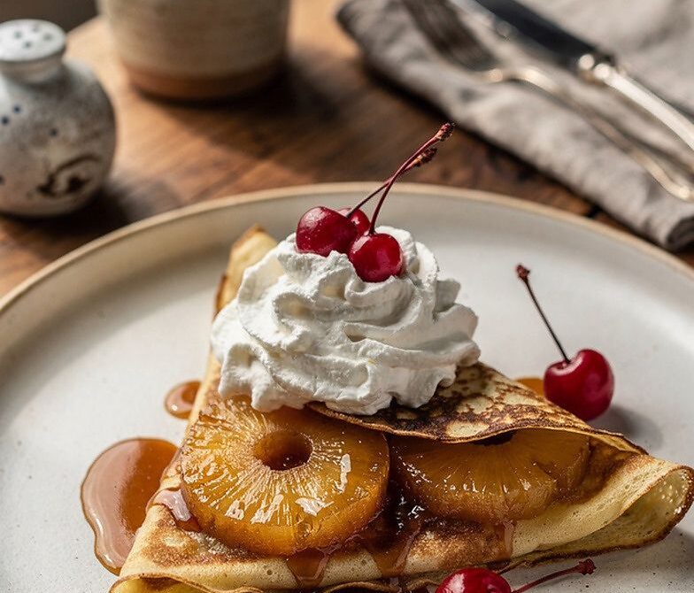 Pineapple Upside-Down Crepes With Whipped Cream and Cherries