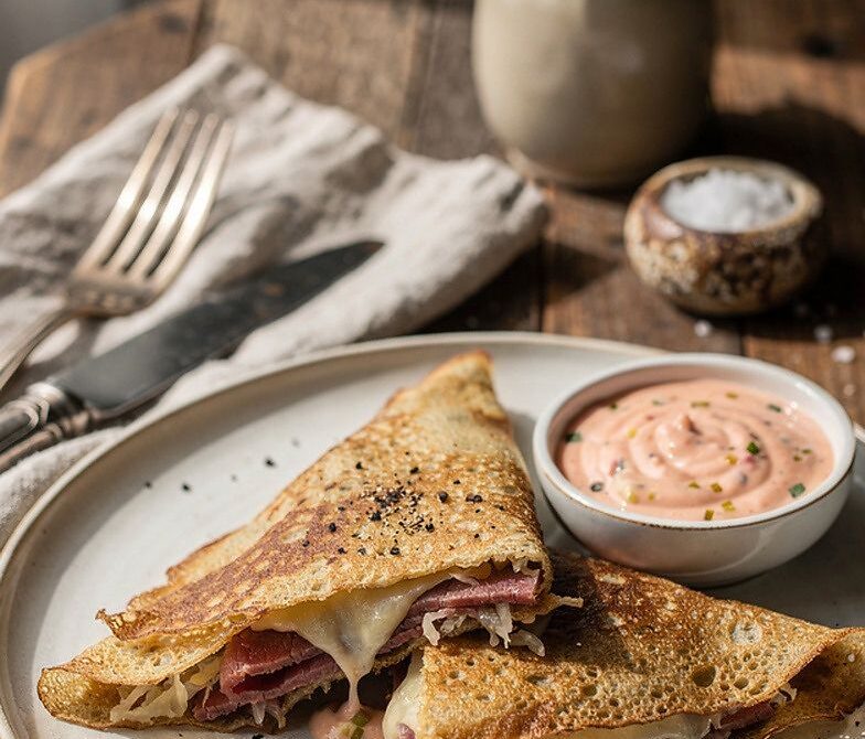 Reuben-Style Savory Crepes With Corned Beef, Swiss, and Sauerkraut