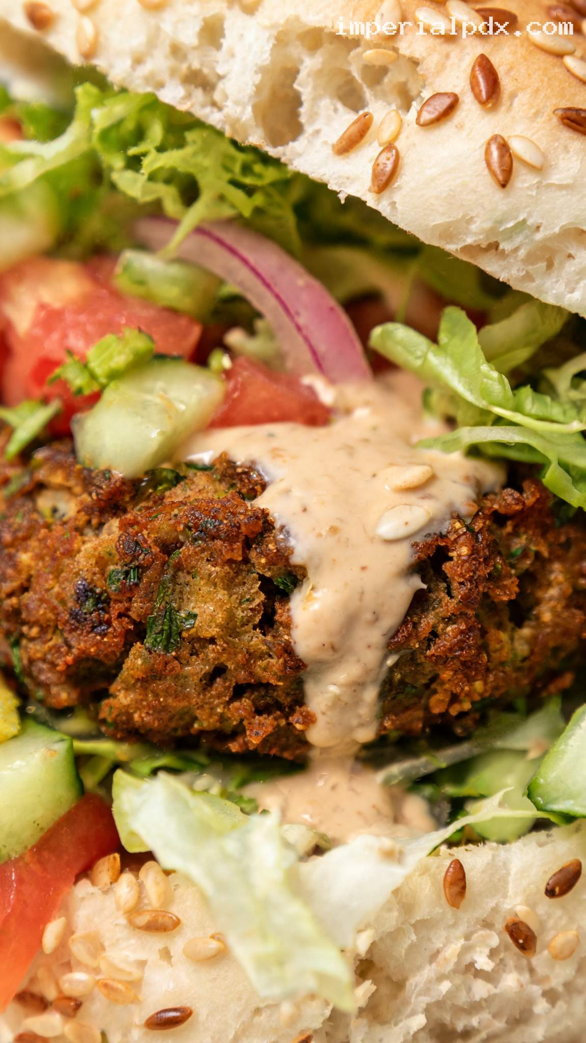 Falafel Burger With Tahini Sauce and Pickled Onions – Closeup