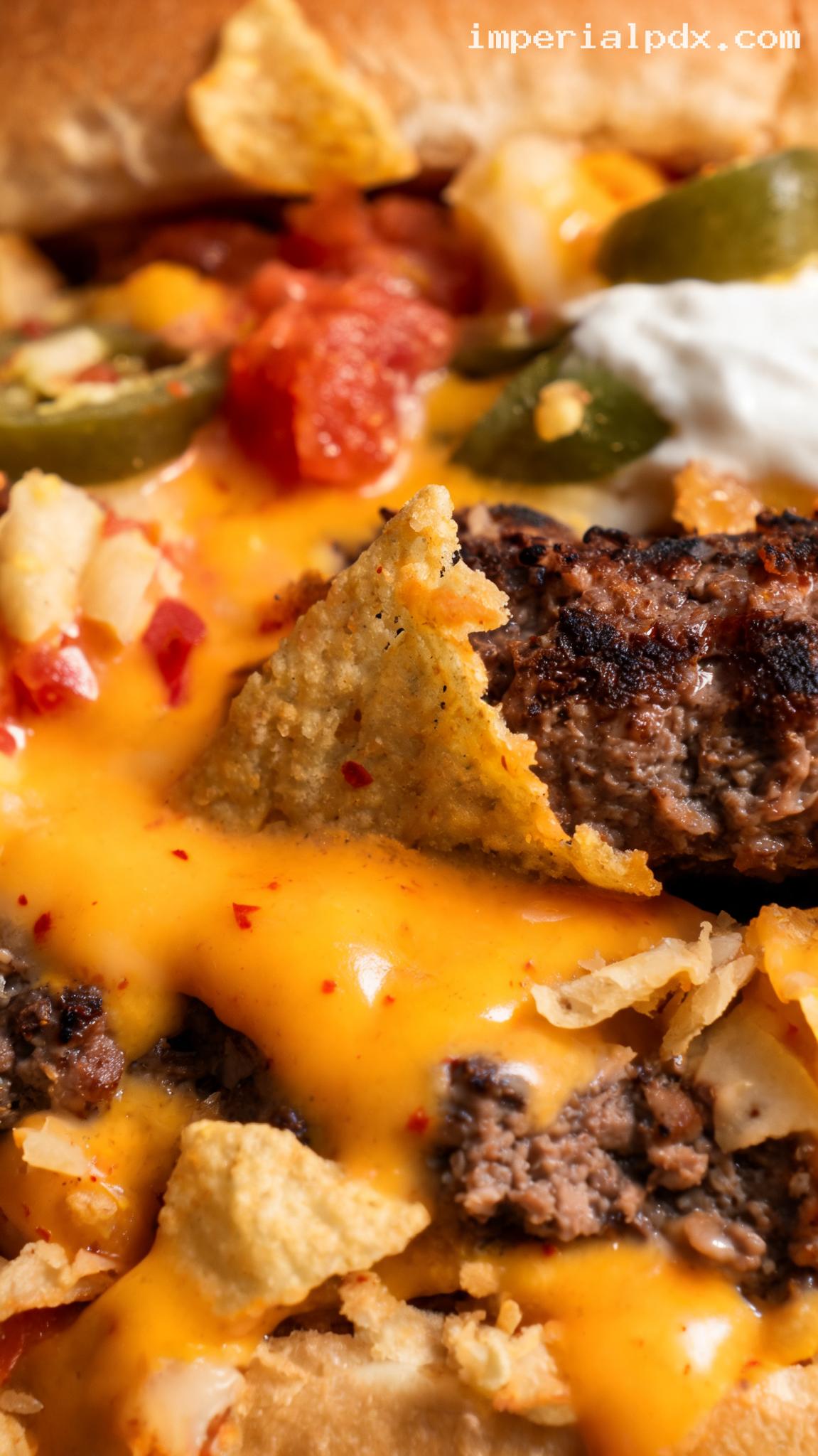 Loaded Nacho Burger With Cheese Sauce and Jalapeños – Closeup
