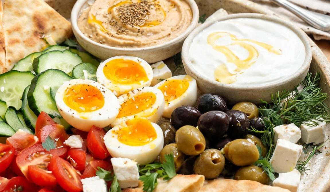 Mediterranean Breakfast Platter With Eggs, Olives, and Hummus