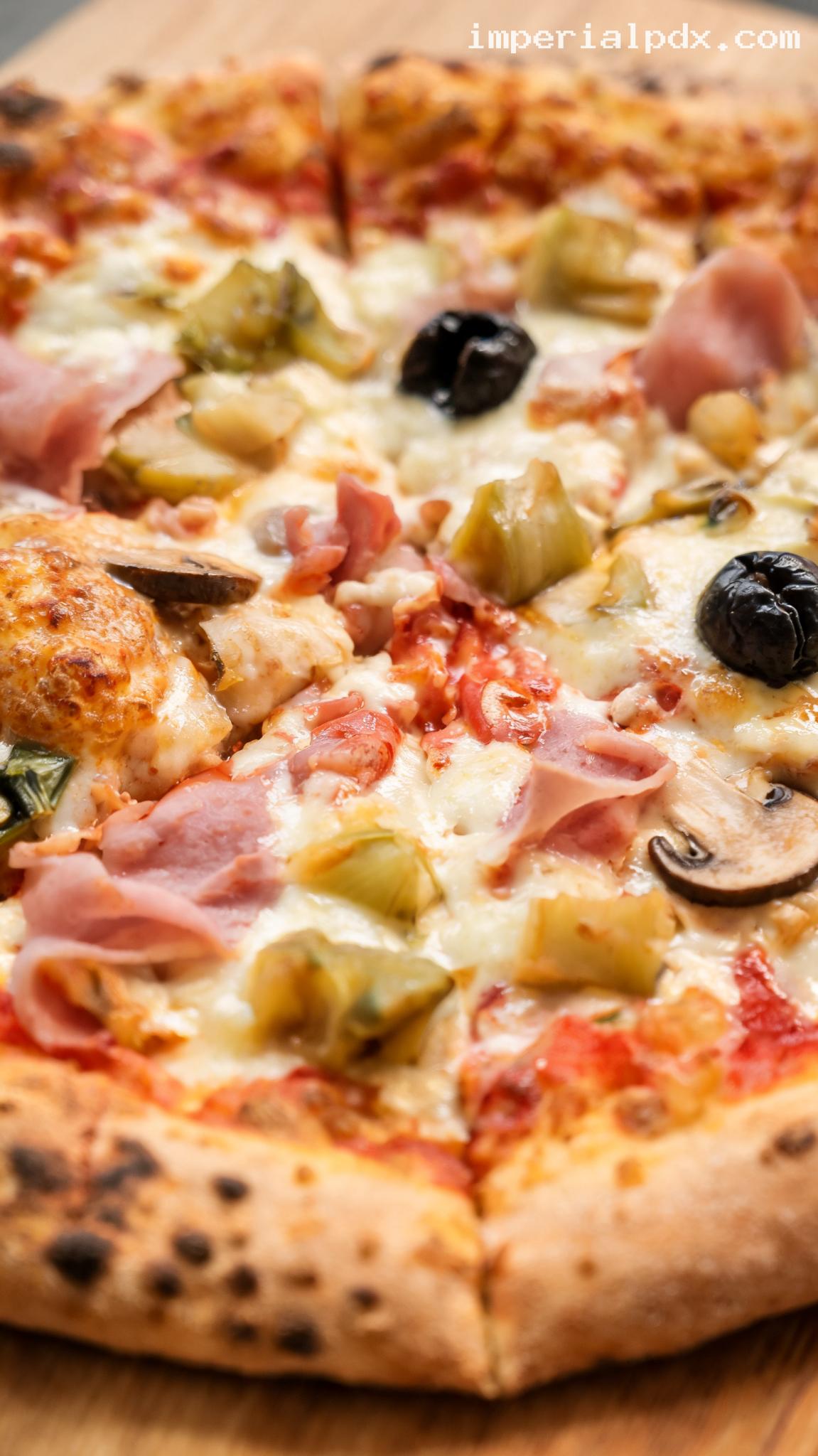 Capricciosa Pizza with Ham, Artichokes, Mushrooms, and Olives – Closeup
