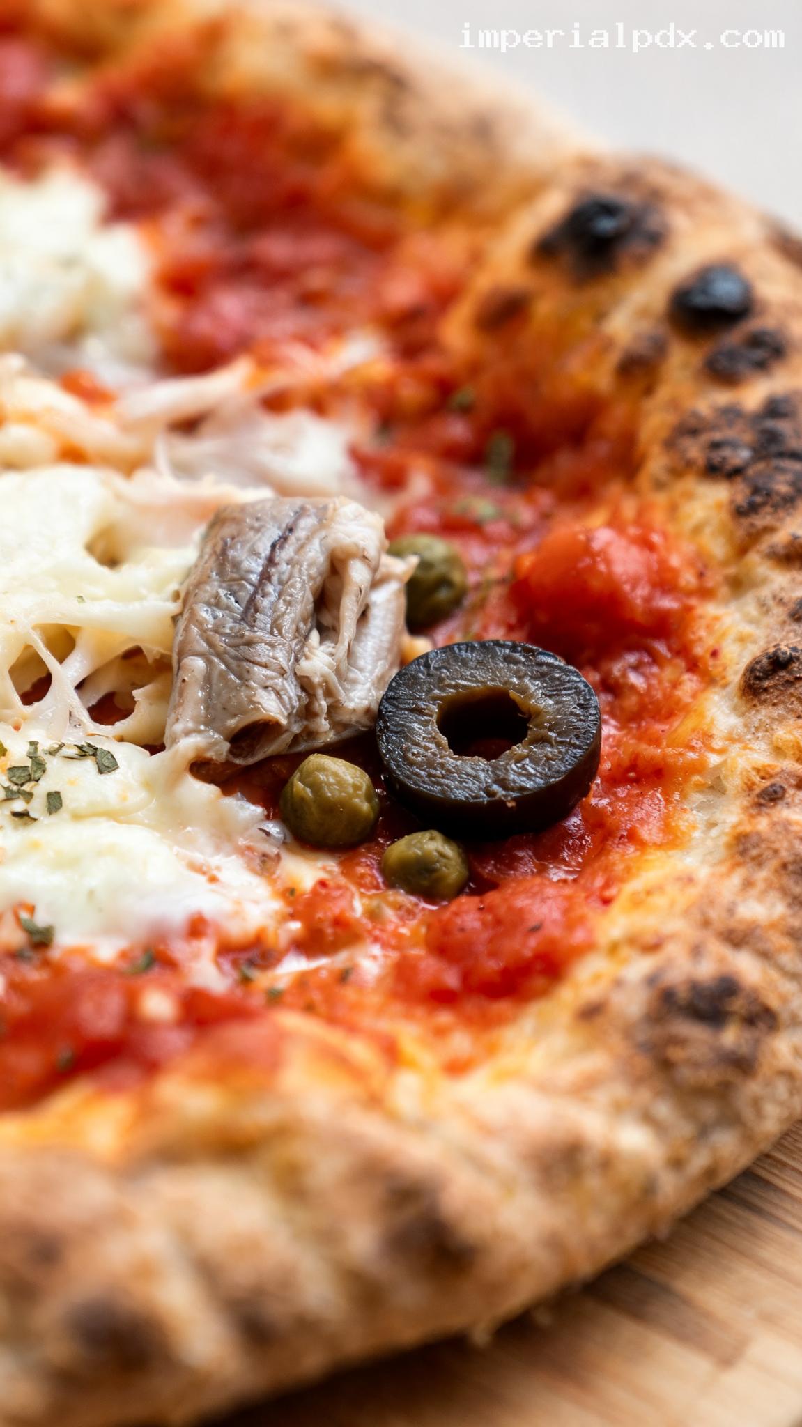 Pizza Napoletana With Anchovies and Olives – Closeup